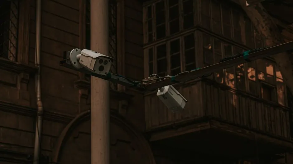 Street security cameras mounted on a pole in an urban environment, highlighting surveillance.